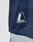 Close-up of the LFDY Mesh Jersey by LIVE FAST DIE YOUNG in dark blue, oversize fit with a V-neck and LIVEFAST patch, styled with light blue jeans featuring white paint splatters. Made from breathable polyester for comfort and style.