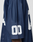 Close-up of a person wearing the LFDY Mesh Jersey by LIVE FAST DIE YOUNG, featuring an oversize fit, navy blue color with white mesh, a V-Ausschnitt, and the number 00 on the sleeve; only part of the upper arm and shoulder is shown.