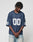 A person with short dreadlocks wears the LFDY Mesh Jersey by LIVE FAST DIE YOUNG in navy blue, featuring an oversize fit, V-Ausschnitt, and number 00 on front and sleeves, standing with hands clasped against a plain background.