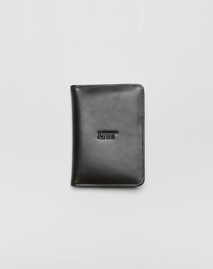 A closed black LFDY Passport Case by LIVE FAST DIE YOUNG with rounded corners, center LFDY embossing, and multiple card slots, shown on a plain light gray background.| plain 