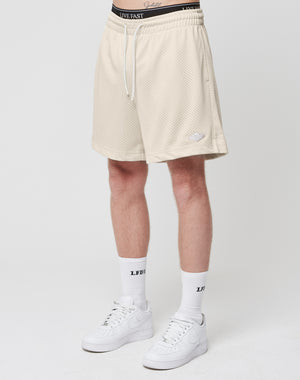 A person wears LIVE FAST DIE YOUNG Basic Mesh Shorts, LFDY-branded white socks, and white Nike sneakers, standing against a plain white background. Only the lower body is shown.