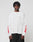 A young man with short dreadlocks models the LIVE FAST DIE YOUNG LFDY We Walked Longsleeve—an oversize white shirt with red flames on the sleeves and small red chest text, made from 100% Baumwolle, against a plain light gray background.