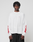 A man stands against a plain background wearing the LFDY We Walked Longsleeve by LIVE FAST DIE YOUNG, a white oversized shirt with red flames on the sleeves and small red chest text, paired with loose black pants.