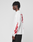 A person in an oversize LFDY We Walked Longsleeve by LIVE FAST DIE YOUNG, with red flame graphics and a bold logo frontprint, stands in profile. The shirt is made from soft cotton. Their hair is styled in short twists.