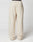 The LFDY Pleated Jogger by LIVE FAST DIE YOUNG is a wide-fit, cream sweatpant made of soft cotton with an elastic waistband and a patch pocket on the left thigh, modeled against a plain white background.