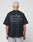 A person with short, bleached blonde hair is shown from behind, wearing a black LIVE FAST DIE YOUNG Basic 280 Tee with a bold backprint. The background is plain white.