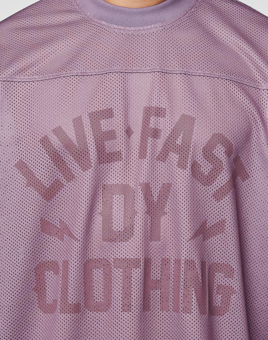 Back view of the LFDY Flash Jersey by LIVE FAST DIE YOUNG, an oversized purple mesh shirt featuring “LIVE FAST DIE YOUNG” and two small lightning bolt graphics.