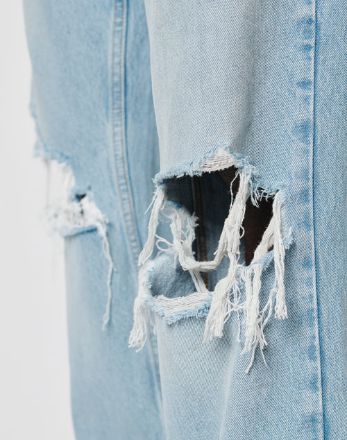 Close-up of LFDY Distressed Baggy Denim by LIVE FAST DIE YOUNG, featuring large distressings and frayed edges that reveal dark inner fabric. Made from 100% Baumwolle in a modern baggy fit.