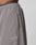 Close-up of a person wearing LFDY Trackpants by LIVE FAST DIE YOUNG—gray, Regular Fit shorts with elastic waistband, side pocket, and reflektierender LIVE FAST Druck near the hem.