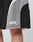 Close-up of a person wearing Basic Trackshorts by LIVE FAST DIE YOUNG in black and gray with elastic waistband and logo print. Live Fast Die Young is written in white on the lower left leg. Part of the thigh is visible.