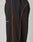 The LIVE FAST DIE YOUNG Live Fast Trackpants are black with an elastic waistband and drawstring, thin orange side piping, a reflective logo print on the thigh, and a wide fit, photographed against a plain background.