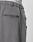 Close-up of the back of gray Wide Casual Pants by LIVE FAST DIE YOUNG with a straight leg and welt pocket. The white underwear’s elastic waistband, featuring LIVE FAST, is visible above the pants.