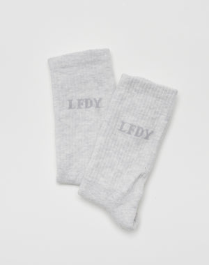 The LIVE FAST DIE YOUNG LFDY Logo Socks (2 Pack) features light gray socks with a slightly darker gray LFDY logo on each, shown against a plain white background.