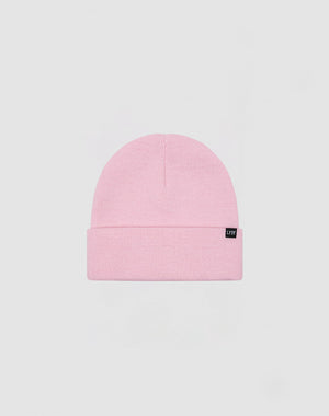The LIVE FAST DIE YOUNG Basic Beanie in light pink polyacryl features a folded brim and a small black flag label on the front, shown against a plain light gray background.