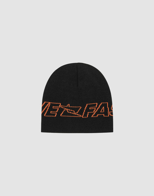 A black Polyacryl Live Fast Jacquard Beanie by LIVE FAST DIE YOUNG features bold, partially visible orange lettering (VE FAST) in a dynamic italic font, part of the Logo Strick LF2503-17393 collection.
