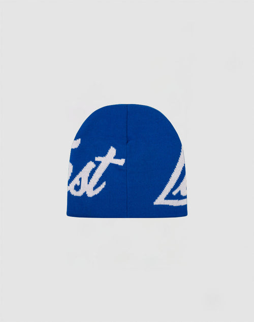 The LFDY Jacquard Beanie by LIVE FAST DIE YOUNG is a blue polyacryl beanie with white script lettering, shown partially visible against a plain white background.