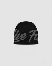 The LFDY Jacquard Beanie by LIVE FAST DIE YOUNG features black polyacryl fabric with a large, subtle gray script design on the front, shown against a light gray background. 