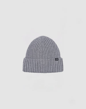 The LIVE FAST DIE YOUNG Rib Knit Beanie in grey is crafted from soft polyacryl, featuring a folded brim and a small black rectangular front tag, shown against a plain white background.