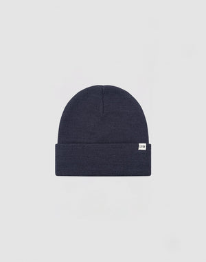 The LIVE FAST DIE YOUNG Basic Beanie is a plain dark navy blue knit, One Size, with a folded brim and a small white Flaglabel tag on the front, displayed against a light gray background.