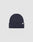 The LIVE FAST DIE YOUNG Basic Beanie is a plain dark navy blue knit, One Size, with a folded brim and a small white Flaglabel tag on the front, displayed against a light gray background.