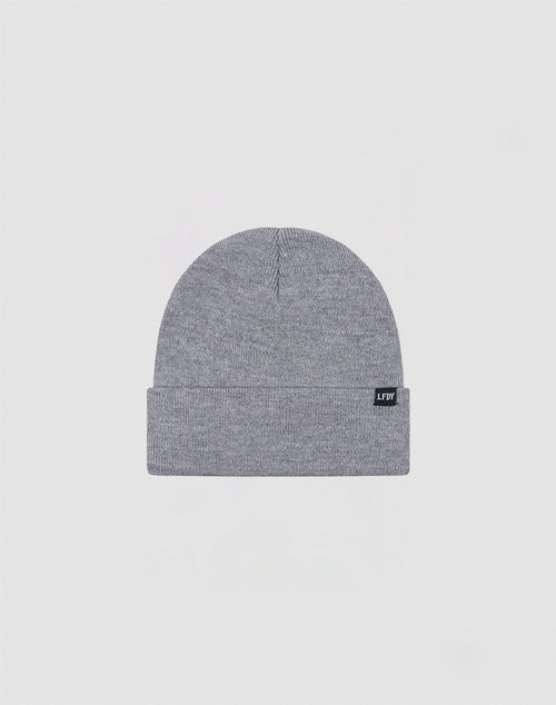 The LIVE FAST DIE YOUNG Basic Beanie (LF2310-14710) is a gray knit polyacryl hat with a folded brim and a small black rectangular tag on the cuff, shown against a plain light background. One Size.