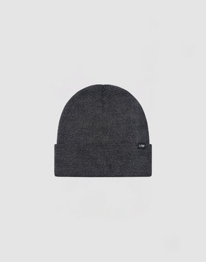 The LIVE FAST DIE YOUNG Basic Beanie is a dark gray cotton hat with a folded brim and a small rectangular tag on the left side, shown on a light gray background. Care instructions are provided for easy maintenance.