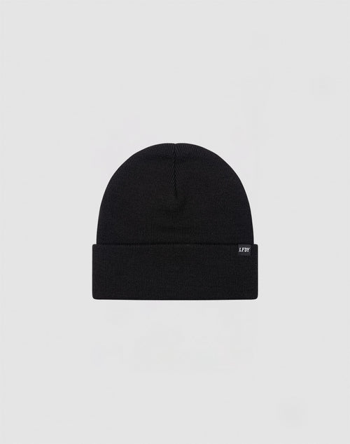 The LIVE FAST DIE YOUNG Basic Beanie is plain black, made from 100% cotton, features a folded brim and a small rectangular side tag. Presented on a light gray background. Care: Gentle washing recommended.