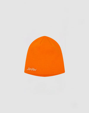 The Script Beanie by LIVE FAST DIE YOUNG is a bright orange polyacryl hat featuring a small white Just Don logo stitch on the lower left side, shown against a plain light gray background.