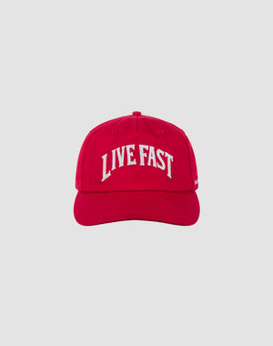 The Live Fast Unstructured Cap by LIVE FAST DIE YOUNG features bold white LIVE FAST text and a Logo-Stick on a red cap with Mit Snapverschluss for easy adjustment. Photographed against a plain light gray background. One size fits most.