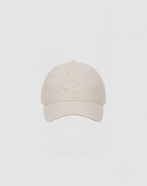 The LIVE FAST DIE YOUNG Basic Cap is a plain beige baseball cap crafted from soft cotton, shown front-facing against a light gray background.