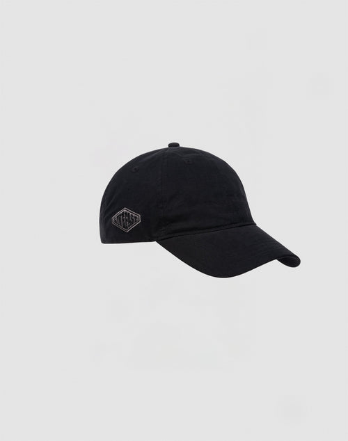 The LIVE FAST DIE YOUNG Basic Cap is a plain black baseball cap with a small embroidered hexagon logo on the side and an adjustable Klettverschluss, shown against a light gray background.