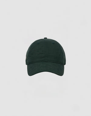 A front view of the LIVE FAST DIE YOUNG Basic Cap, a plain dark green polyester baseball cap with a Klettverschluss, set against a light grey background.