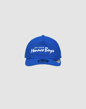A royal blue LFDY X NEW ERA Monaco Boys 9Fifty A-Frame baseball cap by LIVE FAST DIE YOUNG, featuring white “Côte dAzur Monaco Boys” embroidery on the front, displayed against a plain light gray background.