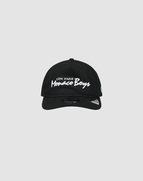 The LFDY X NEW ERA Monaco Boys cap by LIVE FAST DIE YOUNG is a black Retro Crown baseball cap featuring white Côte dAzur Monaco Boys embroidery on the front, shown against a plain light gray background.