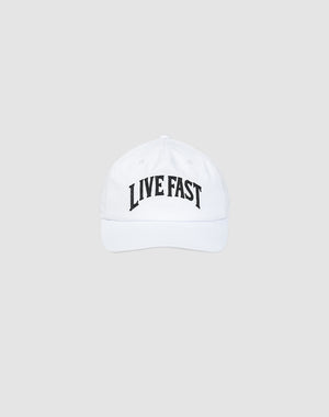 The Live Fast Unstructured Cap by LIVE FAST DIE YOUNG is a white cotton baseball cap with a bold black LIVE FAST logo and a practical snap closure, shown on a plain light gray background.