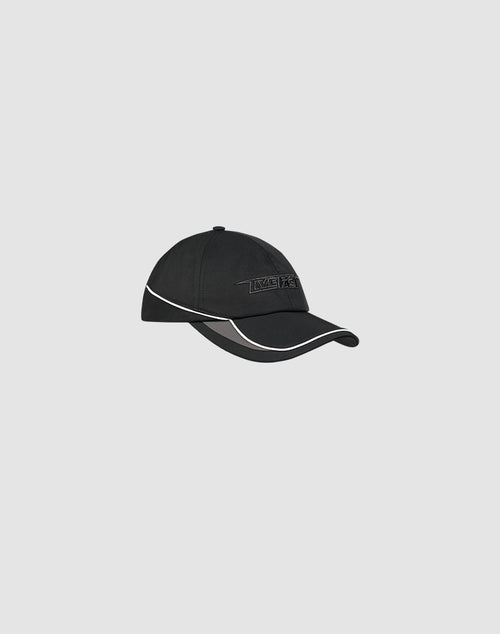 The LIVE FAST DIE YOUNG Live Fast 3000 Cap is a black polyester baseball cap with white trim, Klettverschluss, and subtle logo embroidery, shown on a plain light gray background.