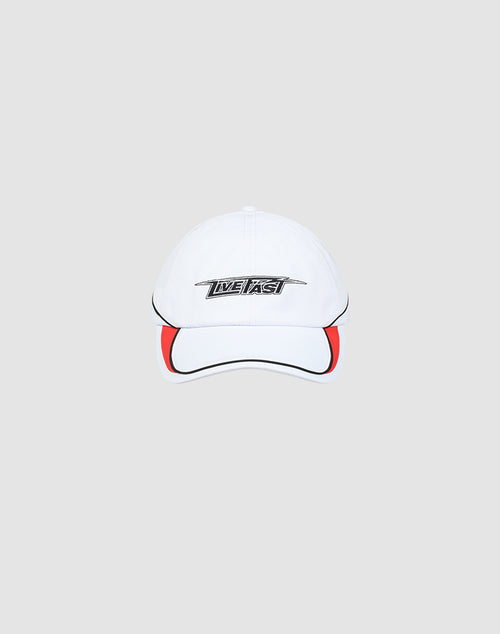 The Live Fast 3000 Cap by LIVE FAST DIE YOUNG is a white baseball cap with black piping, a red brim accent, and LIVE FAST in bold on the front. Features an adjustable Klettverschluss. Shown on a light gray background.