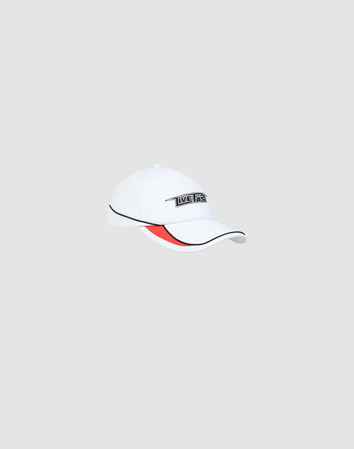 The Live Fast 3000 Cap by LIVE FAST DIE YOUNG features a white crown, black brim pipings, a red underbrim accent, and a small rectangular LIVE FAST Logo-Stick patch on the front, shown against a light gray background.