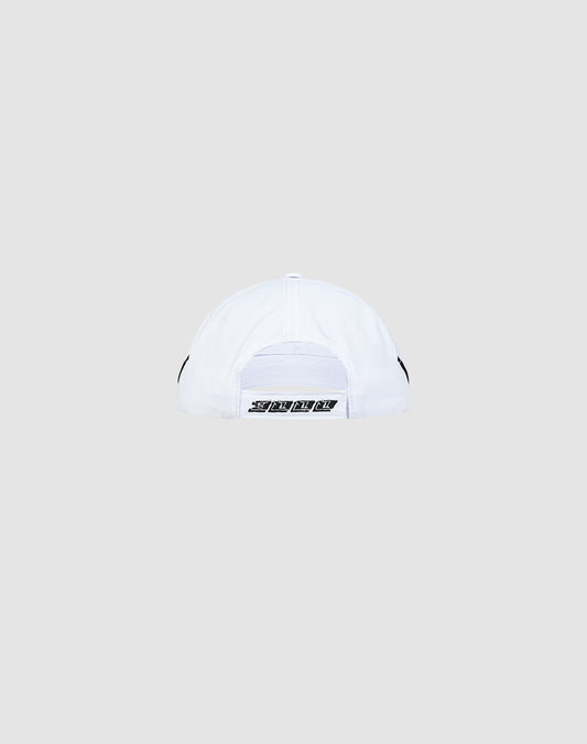 The LIVE FAST DIE YOUNG Live Fast 3000 Cap is a white baseball cap shown from the back, featuring an adjustable black and white Klettverschluss strap with subtle pipings, set against a light gray background.