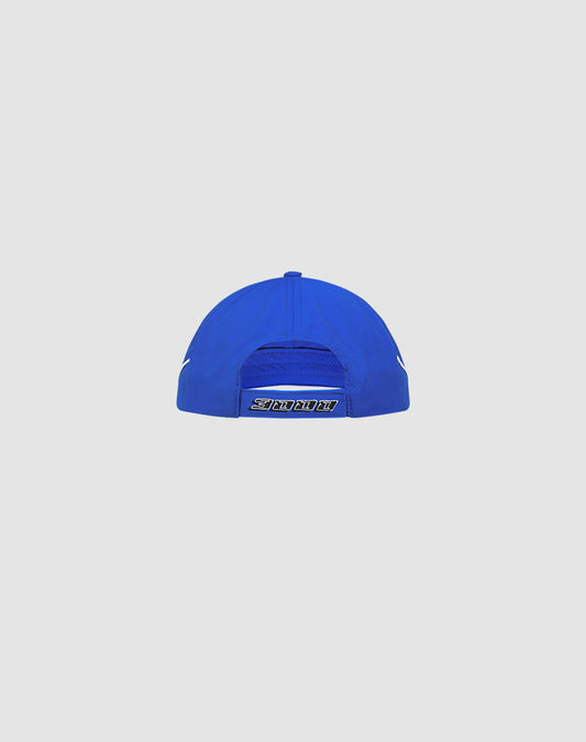 The Live Fast 3000 Cap by LIVE FAST DIE YOUNG is a blue polyester baseball cap shown from the back, with a Klettverschluss adjustable strap and a small Logo-Stick label above the closure, set against a plain light background.