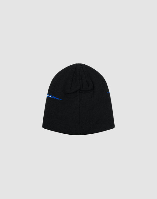 The LIVE FAST DIE YOUNG Live Fast 3000 Beanie is a black knit hat made from soft Polyacryl, with a small blue Logo-Strick detail near the edge, shown flat on a light gray background.