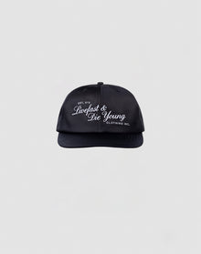The LFDY Satin Snapback by LIVE FAST DIE YOUNG is a black, one-size cap with white 3D-Stick Livefast & Die Young and Clothing Inc. text, snap closure, shown on a plain light gray background.