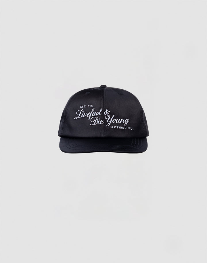 The LFDY Satin Snapback by LIVE FAST DIE YOUNG is a black, one-size cap with white 3D-Stick Livefast & Die Young and Clothing Inc. text, snap closure, shown on a plain light gray background.
