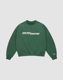 The LFDY Europe Run Sweater by LIVE FAST DIE YOUNG is a forest green oversized crewneck with “LIVE FAST, RACE RUN” in bold white and green front print and small flag patches on the left sleeve near the cuff. Made from soft Baumwolle. | plain