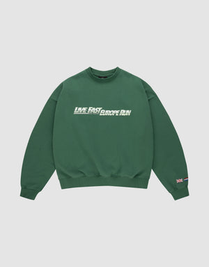 The LFDY Europe Run Sweater by LIVE FAST DIE YOUNG is a forest green oversized crewneck with “LIVE FAST, RACE RUN” in bold white and green front print and small flag patches on the left sleeve near the cuff. Made from soft Baumwolle. | plain