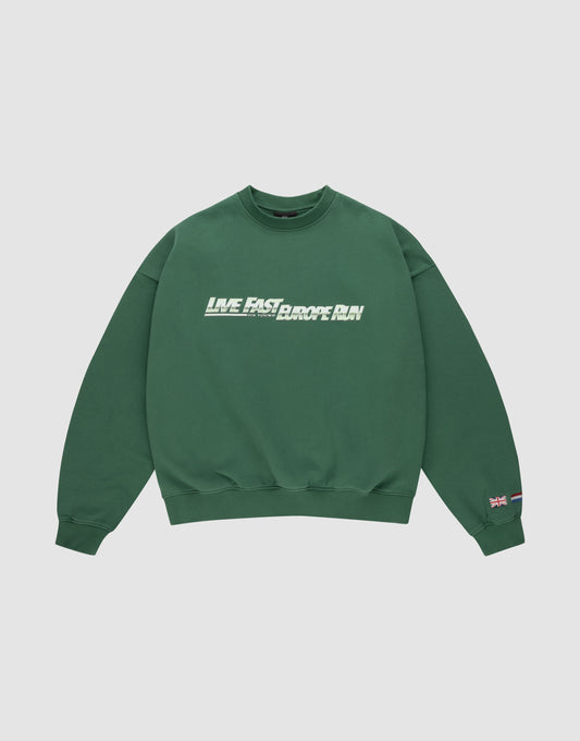 The LFDY Europe Run Sweater by LIVE FAST DIE YOUNG is a forest green oversized crewneck with “LIVE FAST, RACE RUN” in bold white and green front print and small flag patches on the left sleeve near the cuff. Made from soft Baumwolle. | plain