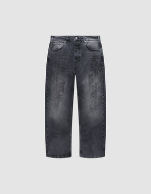 The LFDY Tire Tracks Denim by LIVE FAST DIE YOUNG are wide-leg black jeans with a baggy fit, faded distressed tire track pattern on the front, five pockets, button closure, 100% cotton, shown on a plain light gray background. | plain