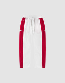 The LIVE FAST DIE YOUNG LFDY Trackpants 3000 are wide fit pants with a white center, red side panels, an elastic waistband, and small white logos on the red hip sections, shown against a light gray background. | plain