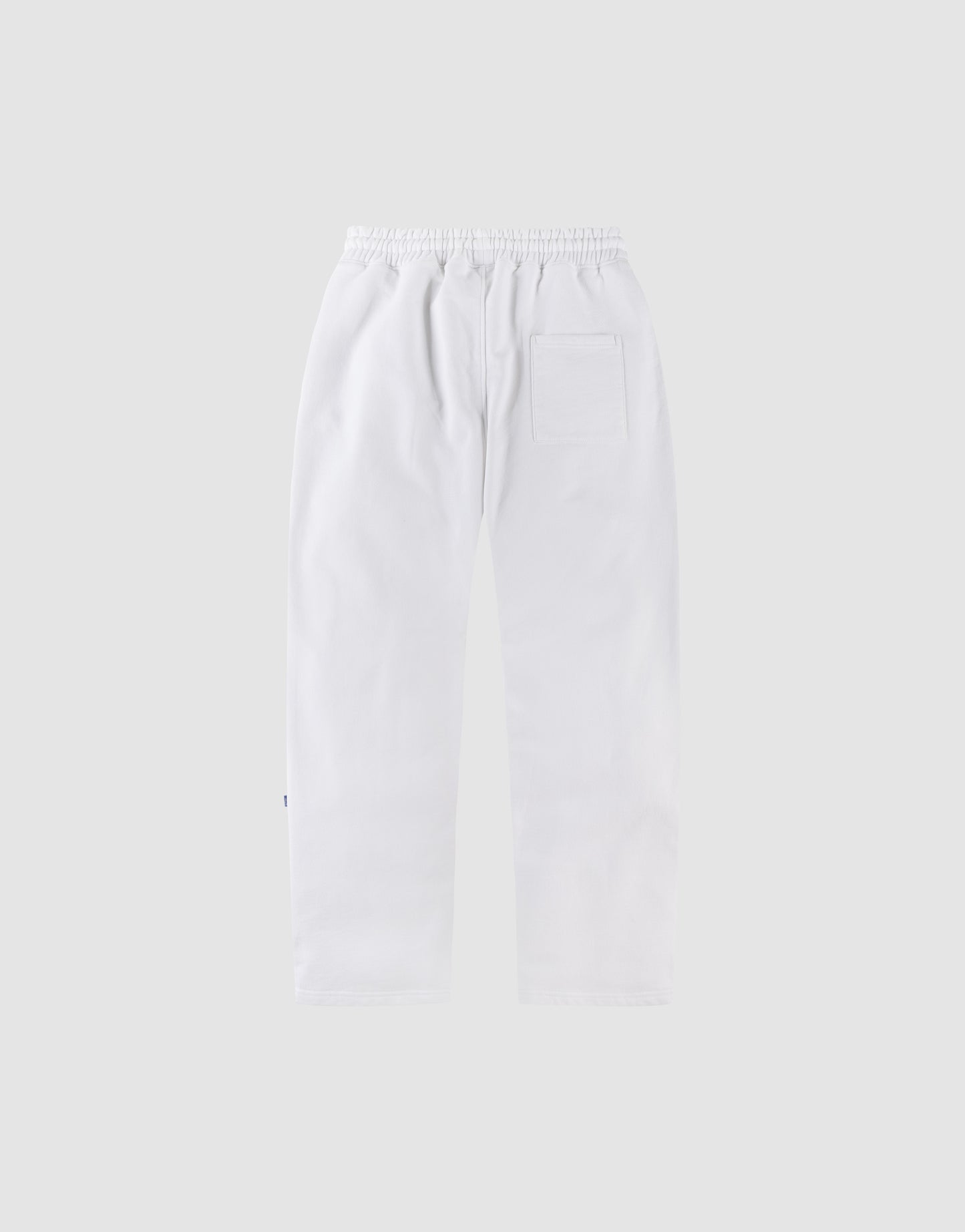 The LFDY Radiator Sweatpants by LIVE FAST DIE YOUNG are wide-fit white pants with an elastic waistband and a single back patch pocket, shown flat on a plain light gray background.