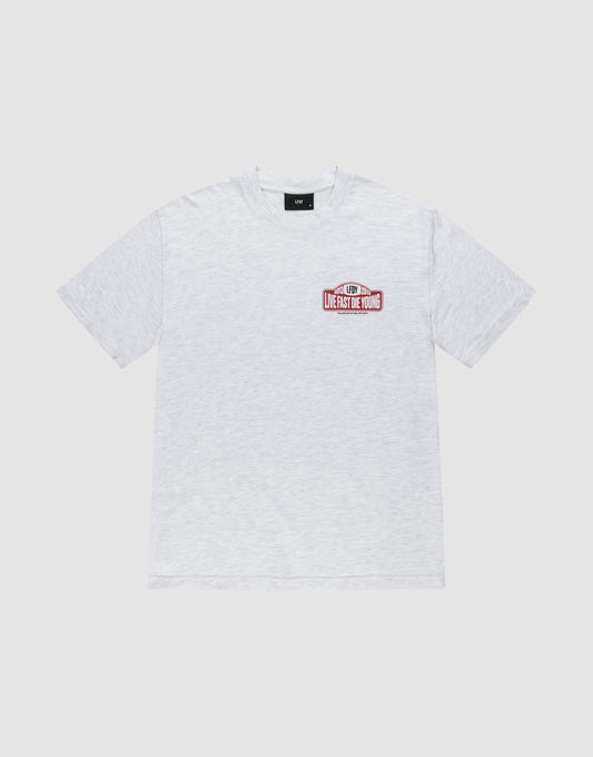 A light gray short-sleeve Regular Fit cotton t-shirt by LIVE FAST DIE YOUNG, the Live Fast 2013 Tee, with a small red and white "University de Young" front graphic. The shirt is laid flat on a plain, light background.